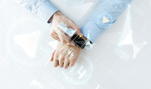 business, future technology and people concept - close up of male hands setting smart watch with virtual screens and charts projection