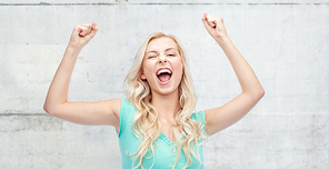 emotions, expressions, success and people concept - happy young woman or teenage girl celebrating victory over gray concrete wall background