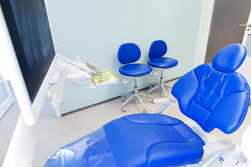 dentistry, medicine, medical equipment and stomatology concept - interior of new modern dental clinic office with chair