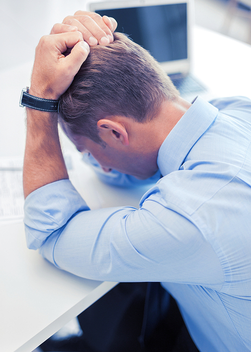 business, office, school and education concept - stressed businessman with papers at work