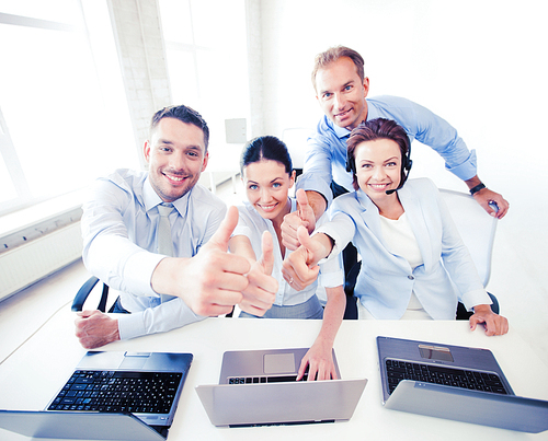 business concept - group of office workers showing thumbs up in call center
