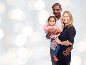 family, children, race and nationality concept - happy multiracial mother, father and little child over holidays lights background