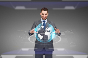 business, technology, multimedia and people concept - smiling businessman working with virtual earth globe projection