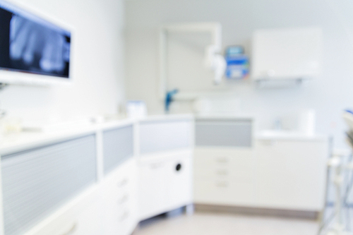 dentistry, medicine and stomatology concept - blurred modern dental clinic office interior bokeh