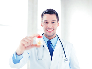 picture of young male doctor with jar of capsules