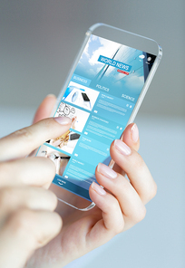 business, technology, internet and people concept - close up of woman hand holding and showing transparent smartphone with news web pages on screen