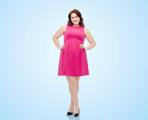 female, gender, portrait and people concept - smiling happy young plus size woman posing in pink dress over blue background