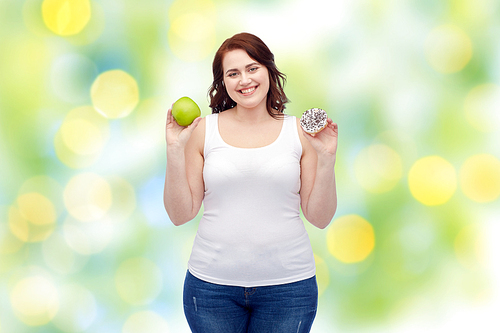 healthy eating, junk food, diet and choice people concept - smiling plus size woman choosing between apple and cookie over green lights background