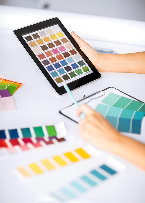 interior design, renovation and technology concept - woman working with color samples for selection