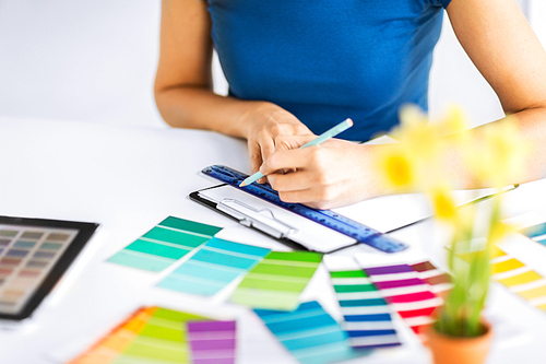 interior design and renovation concept - woman working with color samples for selection