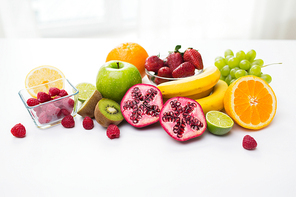 healthy eating, food and  concept- close up of fresh ripe fruits and berries on table