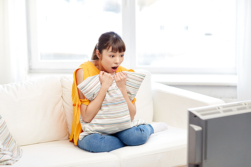 television, leisure and people concept - asian young woman watching tv at home