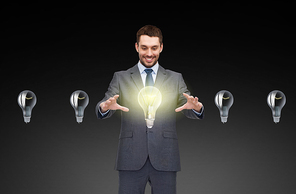 business, inspiration, startup, idea and people concept - smiling businessman working with light bulb icons