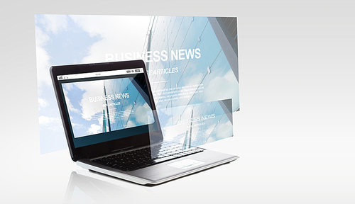 technology and mass media concept - laptop computer with business news on screen