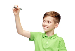 childhood, education, school and people concept - happy smiling boy in green polo t-shirt with marker writing something
