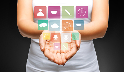 people, media and technology concept - close up of womans cupped hands showing applications menu icons
