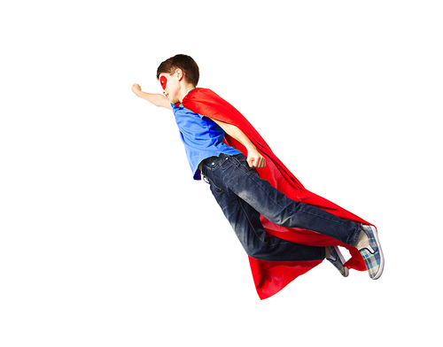 happiness, freedom, childhood, movement and people concept - boy in red superhero cape and mask flying in air