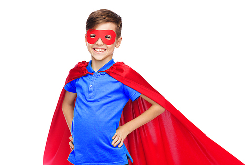 childhood, carnival costume and people concept - happy boy in red superhero cape and mask