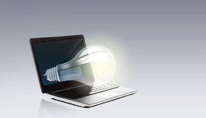 technology, business, idea and startup concept - laptop computer with light bulb
