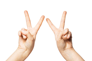 gesture and body parts concept - close up of woman hands showing peace or victory sign