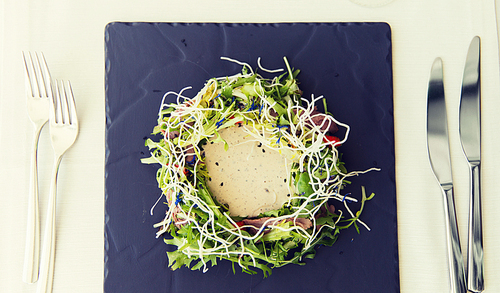 food, culinary, haute cuisine and cooking concept - close up of poultry salad with 밥 noodles and caesar sauce at restaurant