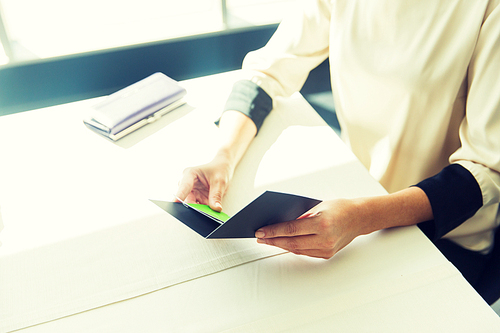 people, expenses, payment and lifestyle concept - close up of woman hands holding restaurant bill