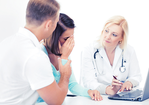 healthcare, medical and technology - doctor with patients looking at laptop