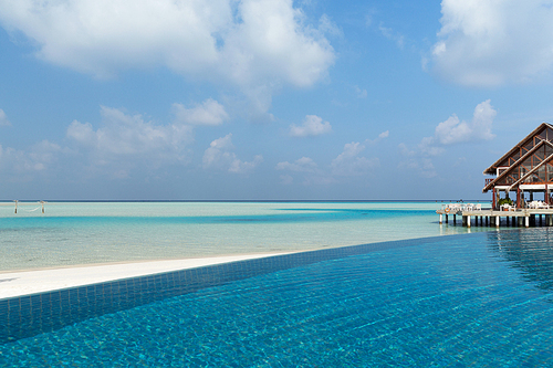 travel, tourism, vacation and summer holidays concept - access to patio or terrace with canopy on maldives beach sea shore