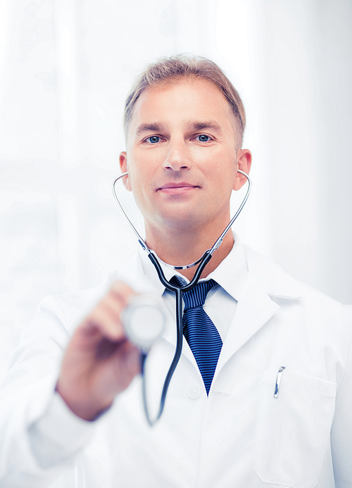 healthcare and medical concept - male doctor with stethoscope