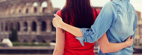 people, homosexuality, same-sex marriage, travel and gay love concept - close up of happy lesbian couple hugging over coliseum in rome background