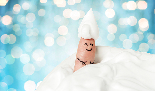 gesture, bath time and body part concept - close up of finger up with foam or whipped cream and smiley face over blue holidays lights background