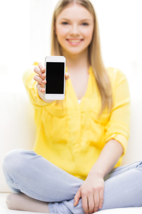 people, technology and advertisement concept - close up of young woman showing smartphone blank screen at home