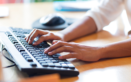 business, education, programming, people and technology concept - close up of african american female hands typing on keyboard