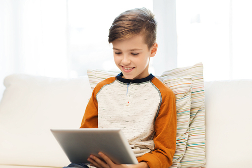 leisure, children, technology and people concept - smiling boy with tablet pc computer at home