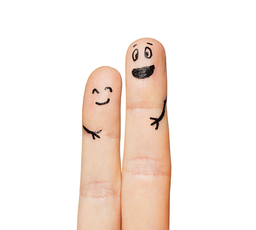 gesture, family, couple, people and body parts concept - close up of two fingers with smiley faces