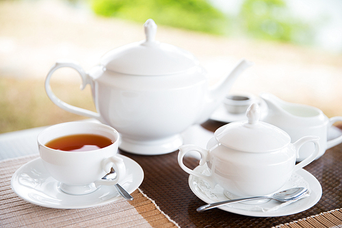 teatime, drink and object concept - close up of tea service on table at restaurant or teahouse