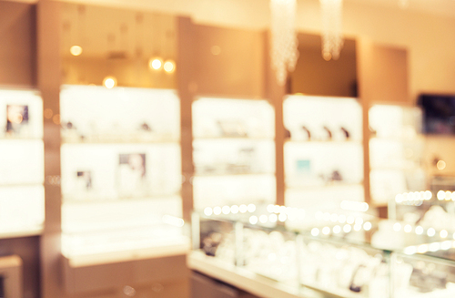 sale, consumerism, shopping and background concept - jewelry store blurred bokeh