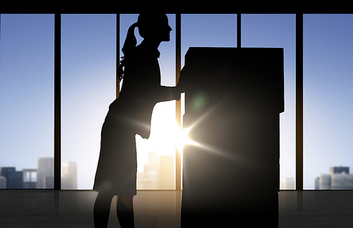 business, logistics, transportation and shipment people concept - silhouette of businesswoman moving boxes over office window background