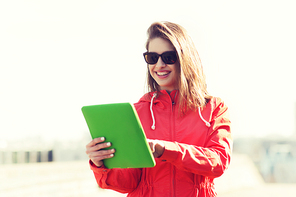 technology, lifestyle and people concept - smiling young woman or teenage girl with tablet pc computer outdoors