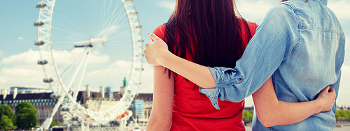 people, homosexuality, same-sex marriage, travel and gay love concept - close up of happy lesbian couple hugging over london ferry wheel background
