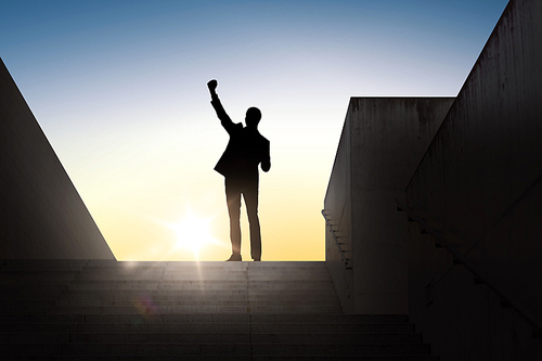 business, success, gesture and people concept - silhouette of happy businessman raising fist and celebrating victory standing on stairs over sun light background