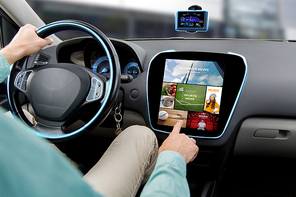 transport, road trip, car driving, technology and people concept - close up of male hand pointing to on-board computer menu