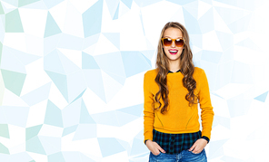 people, style and fashion concept - happy young woman or teen girl in casual clothes and sunglasses over low poly blue background