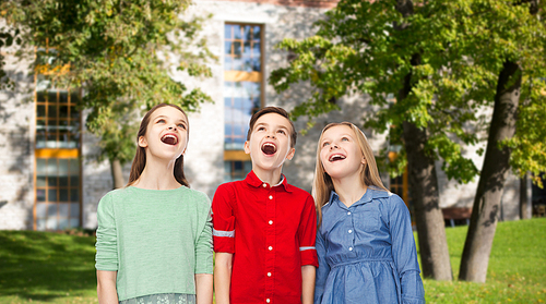 childhood, education, friendship and people concept - happy amazed children looking up with open mouths over summer campus background