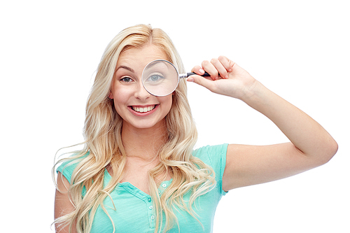 vision, exploration, investigation, education and people concept - happy smiling young woman or teenage girl looking through magnifying glass