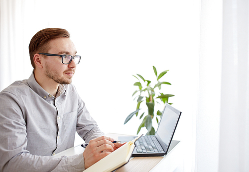 business, startup, inspiration and people concept - happy businessman or creative male worker with notebook or diary thinking at home office