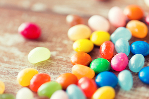 food, junk-food, confectionery and unhealthy eating concept - close up of multicolored jelly beans candies on table