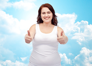 gesture, weight loss and people concept - smiling young plus size woman in underwear showing thumbs up over blue sky and clouds background