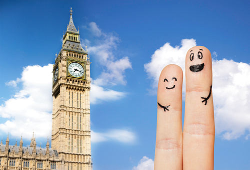 family, couple, travel, tourism and body parts concept - close up of two fingers with smiley faces over big ben clock tower and blue london sky background