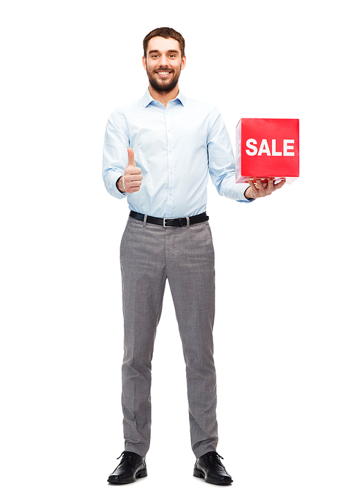 people, shopping, discount and holidays concept - smiling man holding red sale sign and showing thumbs up gesture